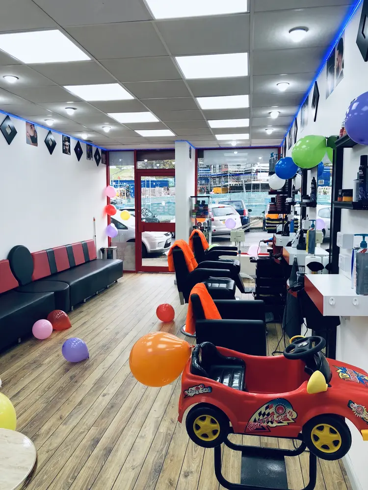 Barber chairs with kids' ride-on car in the shop