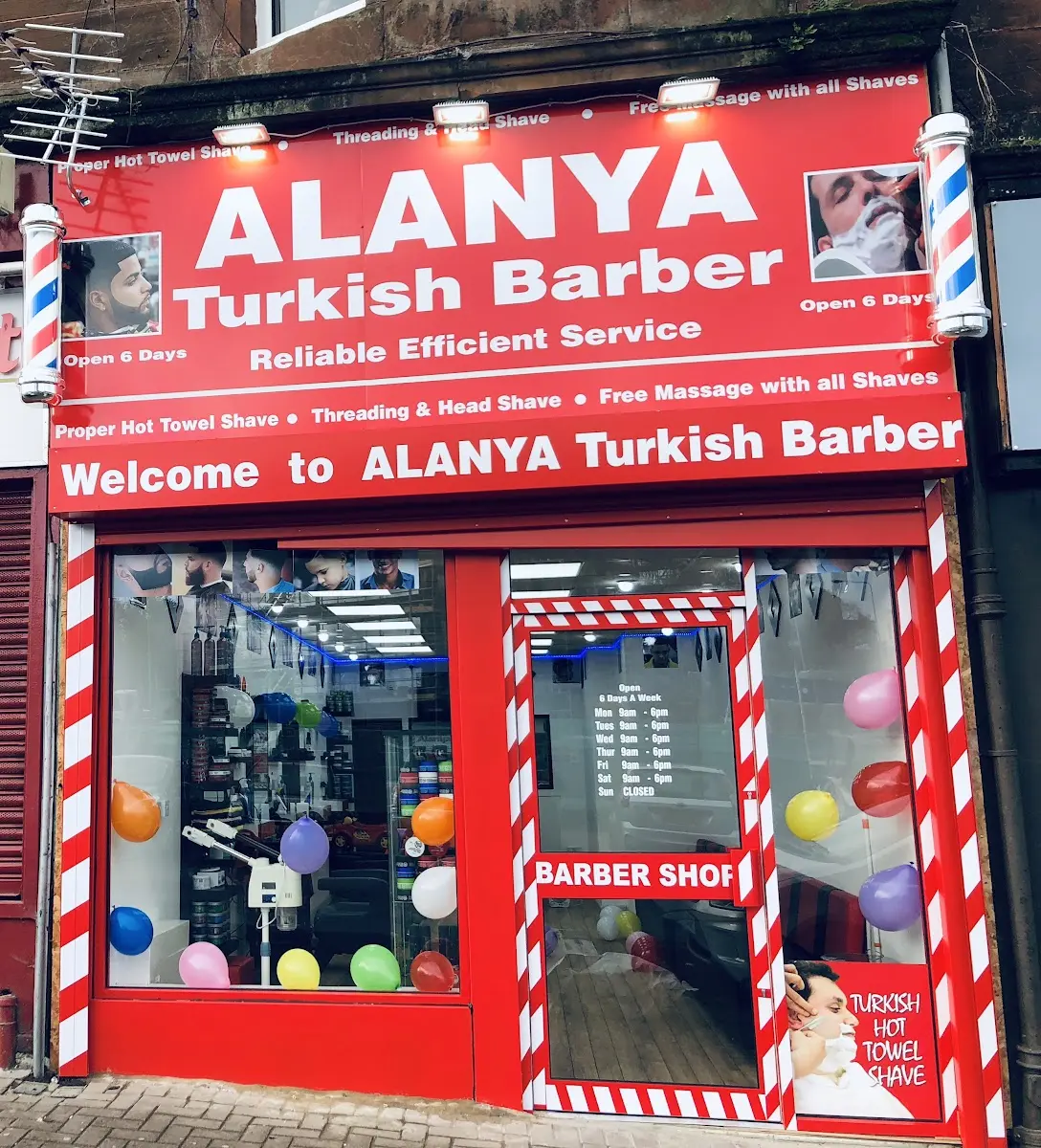 Alanya Turkish Barber shopfront with red fascia and barber poles on Springburn Way, Glasgow